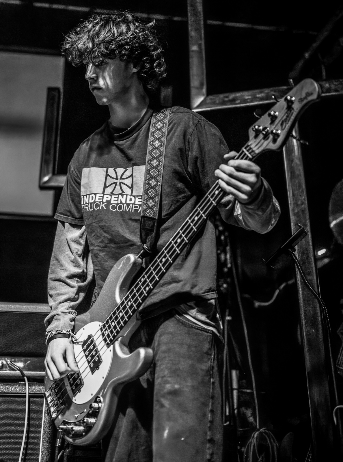 An Aphid bassist performing in black and white